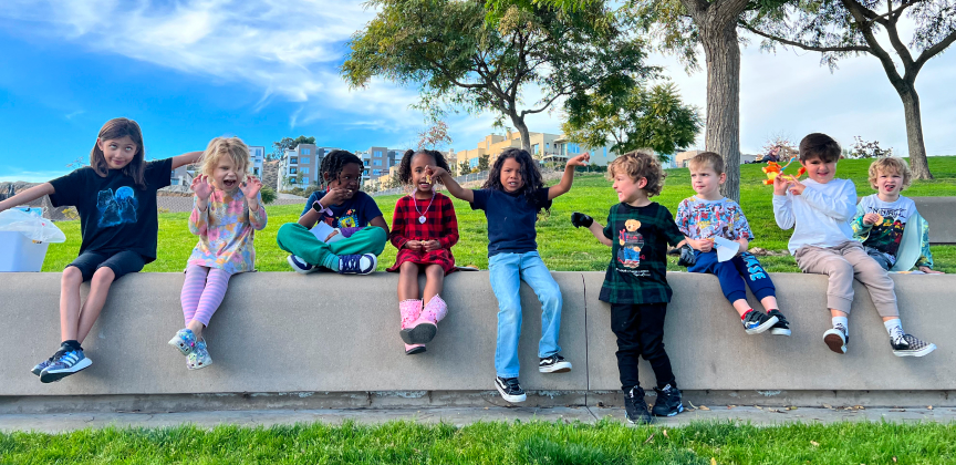 Kids sitting outside by trees