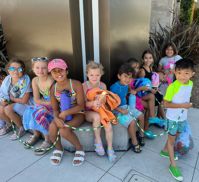 A group of kids sitting together outside