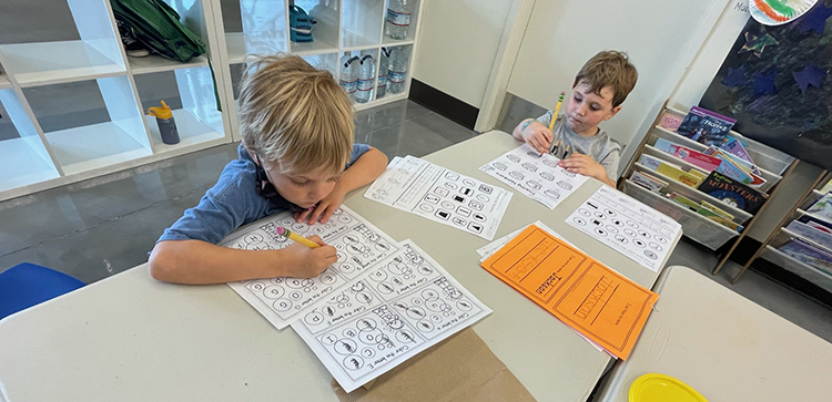 Two kids working on homework together