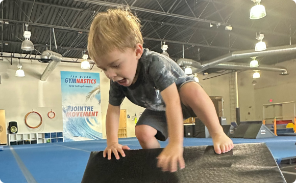 A toddler learning to run up a small ledge