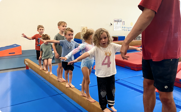 Kids practicing balance with an instructor