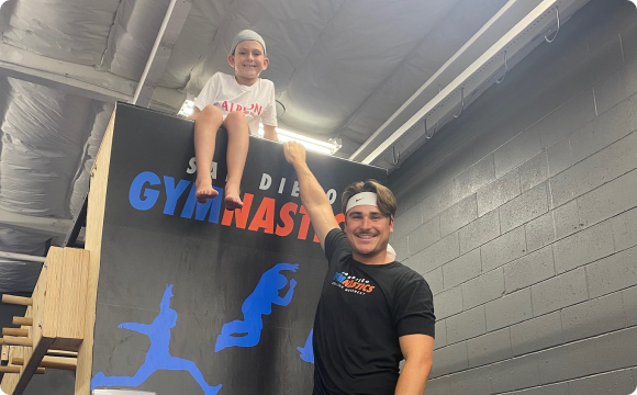 A student and instructor hanging on a ramp posing for a pic