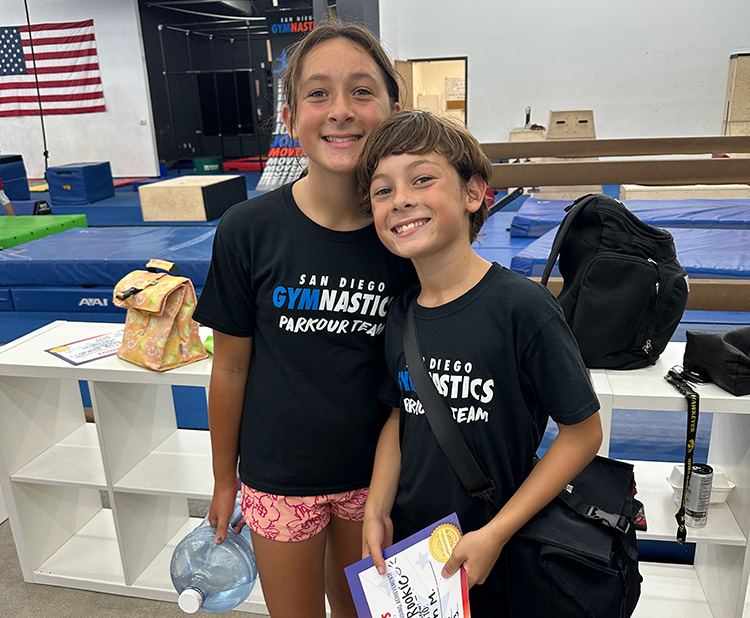 Two students posing and smiling for a photo together