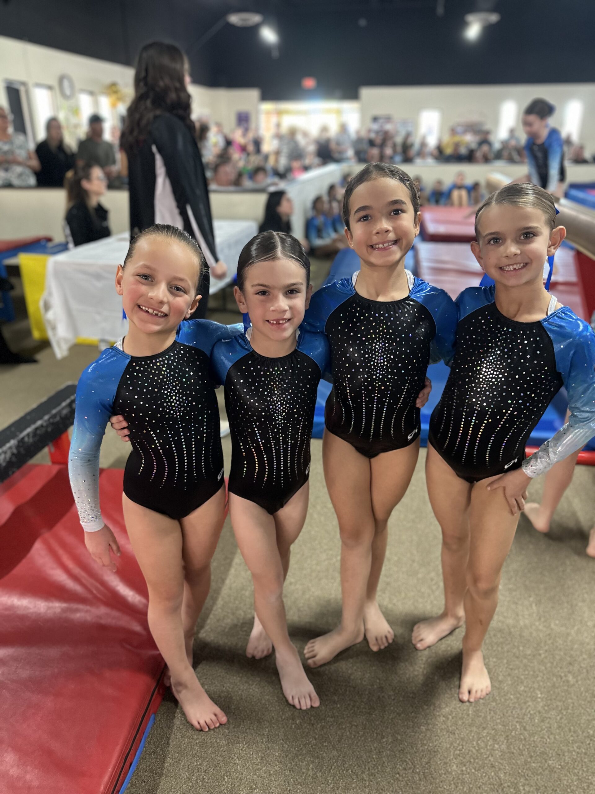 4 San Diego Girls Gymnastics Team wearing blue uniforms