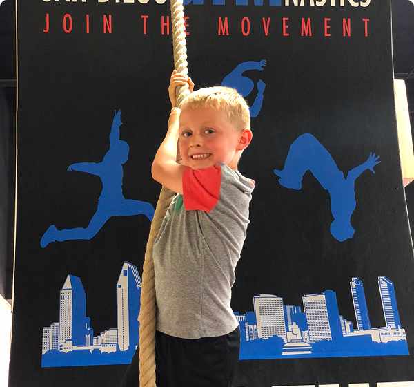 A boy holding onto a rope