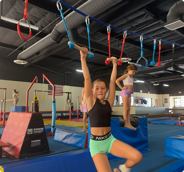 A girl swinging between ropes.